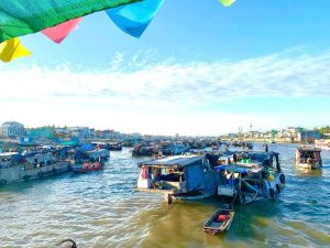 Sunrice floating market with wooden boat