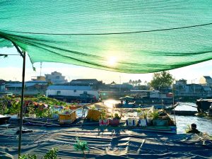 Sunrice floating market with wooden boat