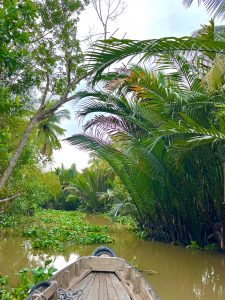Sunrice floating market with wooden boat